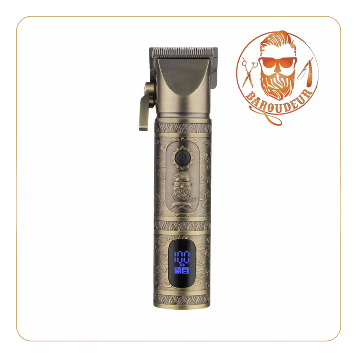 Little Balance Baroudeur clipper with vintage engraved design, gold metal case with LED digital display, steel blades, 2000 mAh Li-ion battery, corded or cordless use, USB-C port, size 175x53x45 mm.